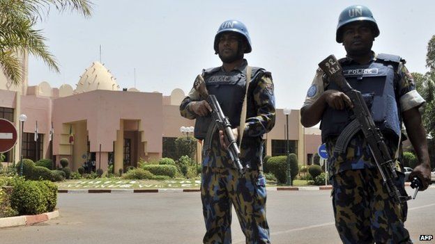 UN peacekeeper police officers stand guard at entrance of Hotel Salem in Bamako on March 8, 2015