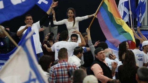 Supporters of Israeli Prime Minister Benjamin Netanyahu"s Likud party react to exit poll figures as they wait for the announcement of the first official results of Israel"s parliamentary elections on March 17, 2015