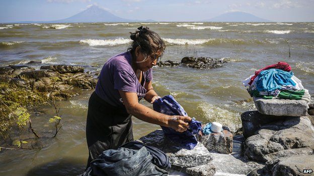 A woman washes clothes on the shore of Cocibolca Lake in Rivas, Nicaragua on 11 December, 2014