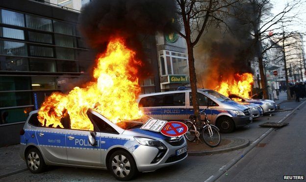 German police cars set on fire by anti-capitalist protesters