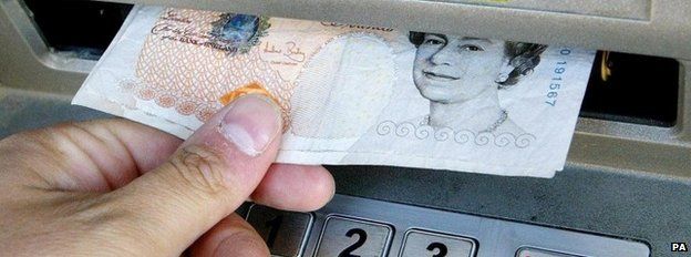 Man taking money out of cash machine