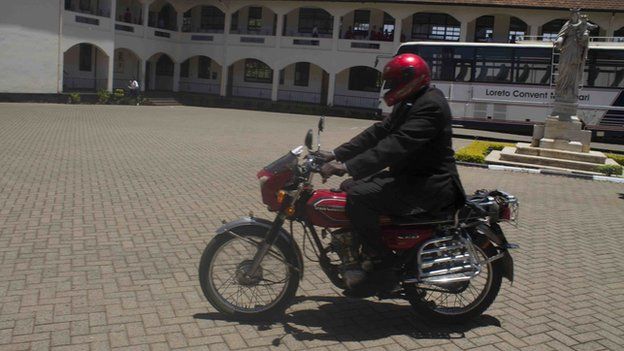 A motorcyclist delivers letters through Nairobi