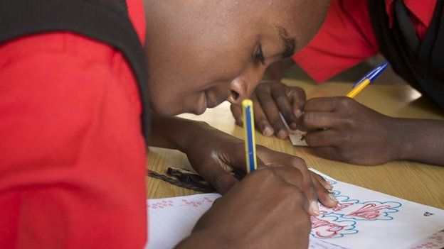 A boy writes a letter at the Starehe Boys' Centre in Nairobi, Kenya