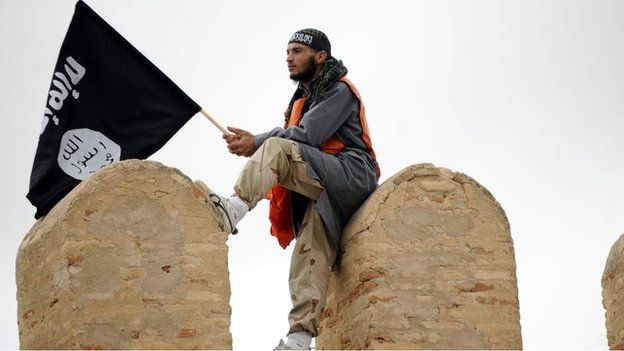 A Tunisian Islamist waves a Salafist flag reading: "There is only one God" during a rally in May 2012 in Tunisia for the Ansar al-Sharia's national congress