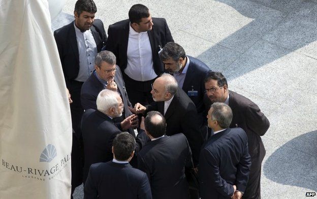 Iran's Zarif (left) talks to Ali Akbar Salehi of the Atomic Energy Organization of Iran, in Lausanne