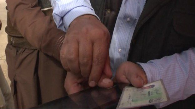 Sim card registration in the village of Tirkhi Nangyal, Pakistan