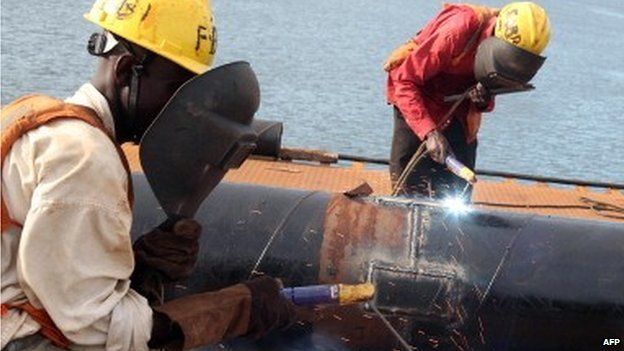 Local Tanzanian welders work on the construction site of an ultra modern bridge by a Chinese company at Kurasini area in Dar es Salaam on 23 March 2013