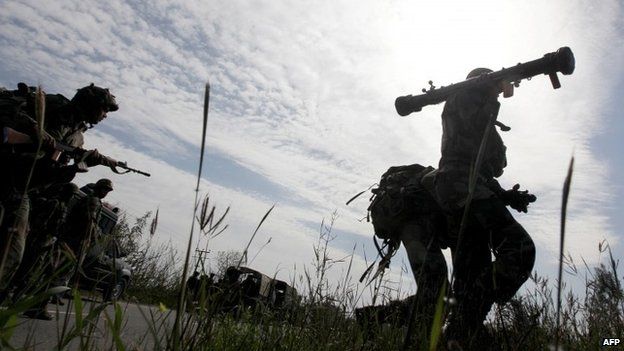 Indian security personnel run to take position during an attack by militants at Raj Bagh police station in Kathua district on March 20, 2015.