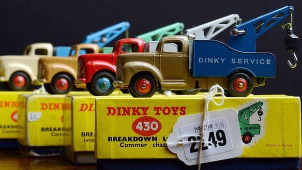 Row of Dinky trucks sitting on top of their original boxes