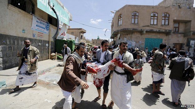 Injured man carried from scene of bombing in Sanaa. 20 March 2015