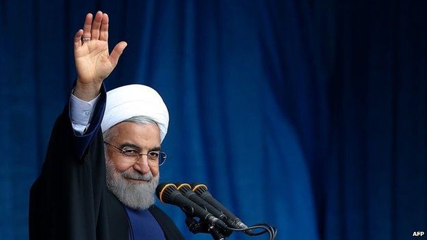 File photo: Iranian President Hassan Rouhani waving to the crowd during a speech in Qom, 25 February 2015