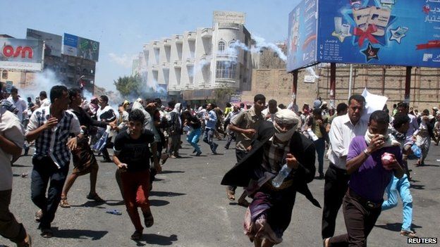 Protesters flee tear gas in Taiz in Yemen as the city was seized by Houthi rebels, 22 March 2015