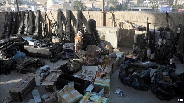 A Pakistani paramilitary soldier inspects weapons recovered following a raid on the offices of the Muttahida Qaumi Movement (MQM) political party in Karachi on March 11, 2015