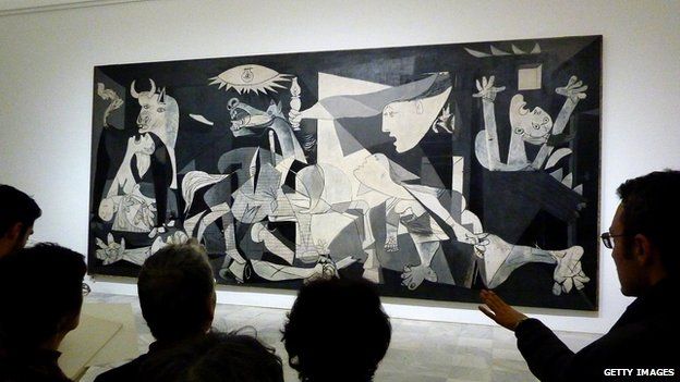 People look at the Guernica painting by Pablo Picasso at the Reina Sofia museum in Madrid