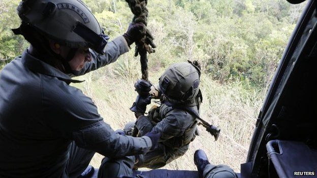 Colombian anti-narcotics policemen prepare to disembark a helicopter in a rural area of Choco on 24 February, 2015