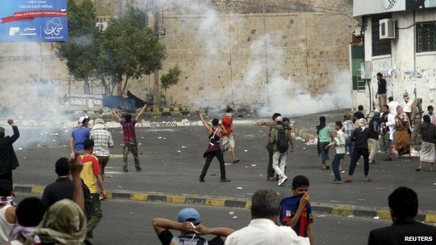 Pro-Houthi police troopers use tear gas to disperse anti-Houthi protesters in Yemen"s southwestern city of Taiz March 23, 2015