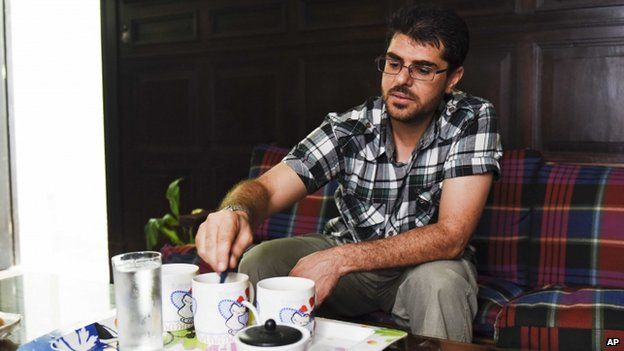 Abdelhadi Faraj, from Syria, adds sugar to a cup of coffee - 24 Feb 2015