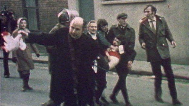 Father Edward Daly leading a group of people carrying the dying body of Jack Duddy, shot by soldiers in Derry on Bloody Sunday, 30 January 1972