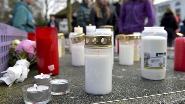Lit candles are placed outside the Josef-Koenig high school in Haltern March, 24, 2015