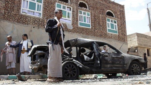 Houthi fighters stands next to a damaged after a suicide bomb attack on a mosque in Sanaa, Yemen (20 March 2015)