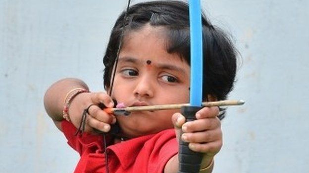 Two-year-old Indian archer Dolly Shivani Cherukuri takes aim during a world record target attempt at The Volga Archery Academy in Vijayawada some 250kms south-east of Hyderabad on March 24, 2015