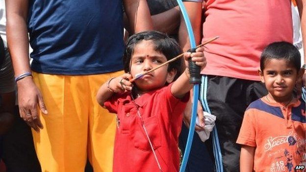 Two-year-old Indian archer Dolly Shivani Cherukuri takes aim during a world record target attempt at The Volga Archery Academy in Vijayawada some 250kms south-east of Hyderabad on March 24, 2015