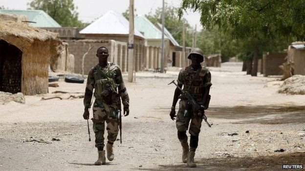 Nigerien soldiers patrol on foot in the recently recaptured northern town of Damasak on 24 March 2015