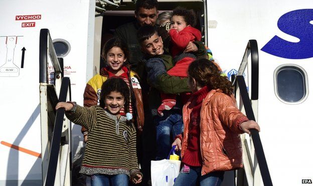 A Syrian refugee family disembarks from a plane on the airport Hannover-Langenhagen, in Langenhagen, Germany, 11 March 2015