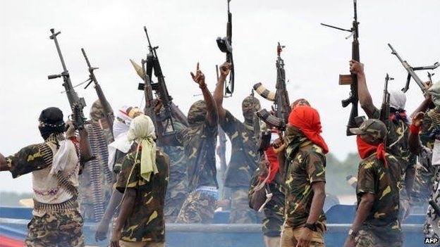 Fighters with the Movement for the Emancipation of the Niger Delta (MEND) raise their riffles to celebrate news of a successful operation by their colleagues against the Nigerian army in the Niger Delta on 17 September 2008