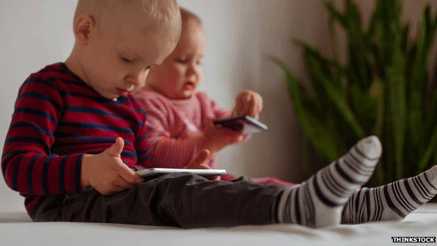 Babies with tablet and phone