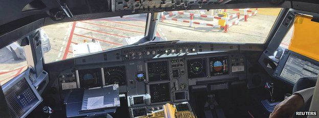A pilot stands inside the cockpit during boarding for the Germanwings flight 4U9441, formerly flight 4U9525