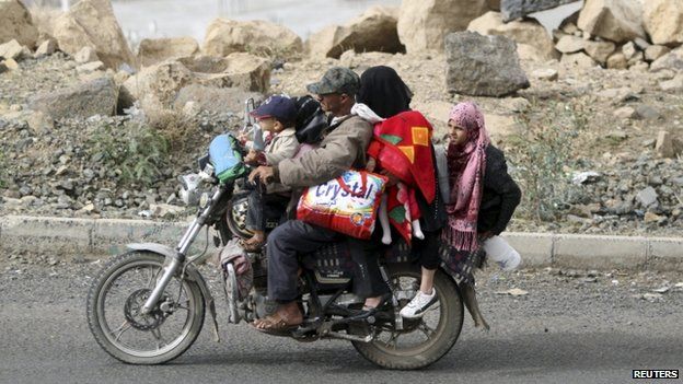 A man flees with his family and their belongings on a motorcycle in Sanaa March 28, 2015