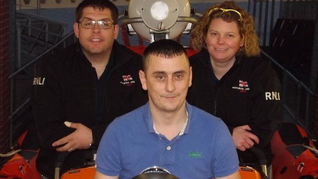 Michael Soley with two members of the RNLI crew which saved him