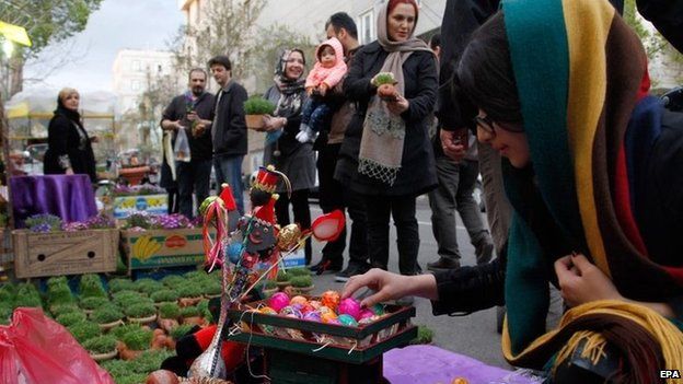 Iranians go shopping at a street market