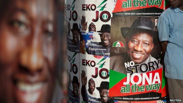 A man stands in front of electoral campaign posters in Lagos March 30, 2015