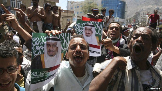 Anti-Houthi protesters hold posters of Saudi King Salman bin Abdulaziz al-Saud during a demonstration to show support for Saudi-led air strikes on 29 March, 2015