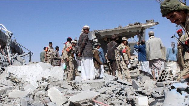 Soldiers and Houthi fighters inspect the damage caused by air strikes on the airport of Yemen's northwestern city of Saada on 30 March, 2015