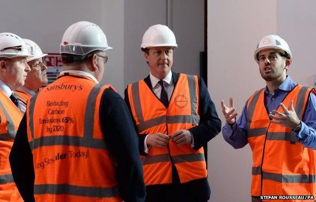 Conservative party leader David Cameron (second right) meets workers in the new digital hub, under construction at the Sainsbury's head office in Holborn London