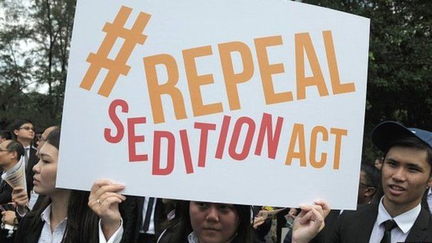 In a photo taken on 16 October 2014, a Malaysian Lawyer holding a placard outside the Parliament house during a rally to repeal the Sedition Act in Kuala Lump