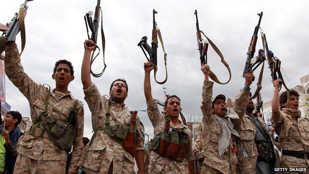 Houthi rebels brandish their weapons during a gathering in Yemen's capital, Sanaa