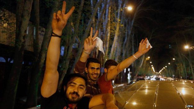 Iranians celebrate in the street of Tehran after the agreement was announced