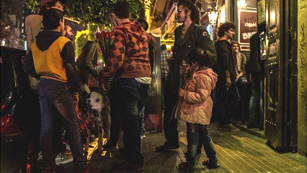 Syrian child refugee besides group of people in Beirut