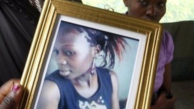 Someone holding a photo of a woman who died in the Garissa University College attack