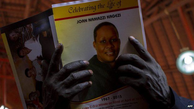 A man holds a programme during the church service for late acting assistant director of public prosecution Joan Kagezi on April 2, 2015 in Kampala