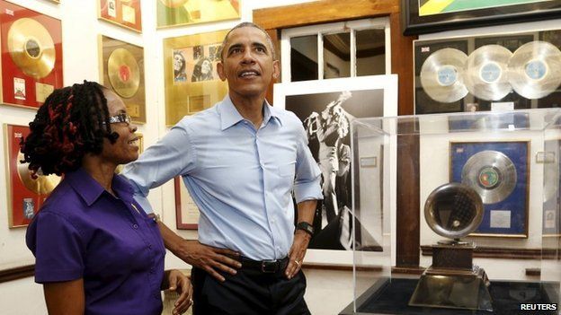 U.S. President Barack Obama gets a tour of the Bob Marley Museum from a staff member Natasha Clark (L) in Kingston, Jamaica April 8, 2015.