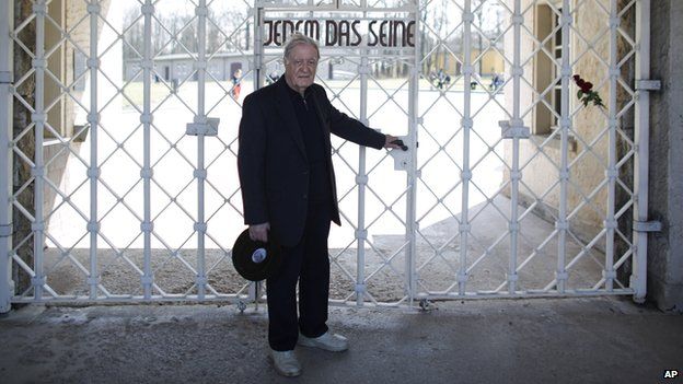 Henry Oster poses at the gate of the former Nazi concentration camp Buchenwald on 10 April 2015