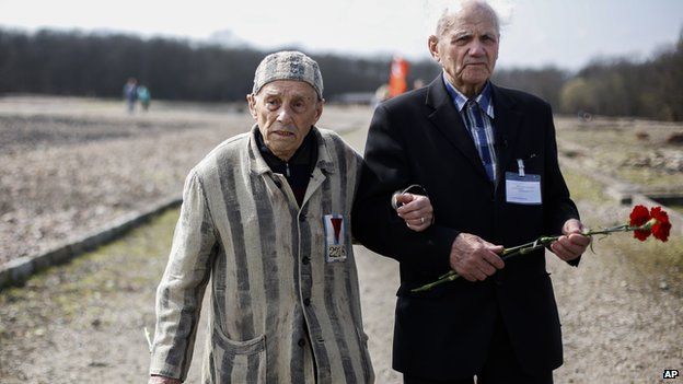 Buchenwald survivors Alexander Bytschok, left and Andrej Moiseenko walk through the former Nazi concentration camp Buchenwald on 11 April, 2015