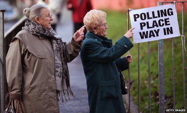 Ladies pointing towards a polling station
