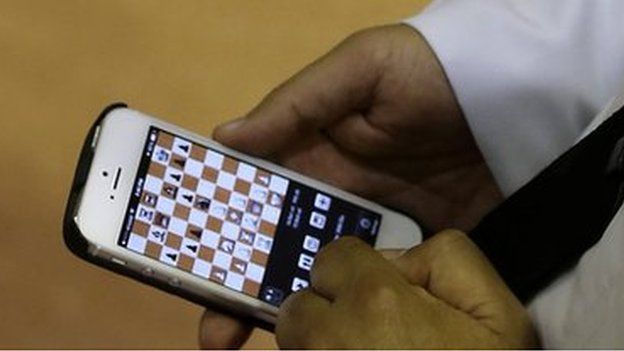 An Emirati man plays chess on his mobile phone during the FIDE World Rapid & Blitz Chess Championships 2014 at Dubai Chess and Culture Club (19 June 2014)