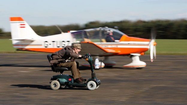 Colin Furze races his mobility scooter against a plane